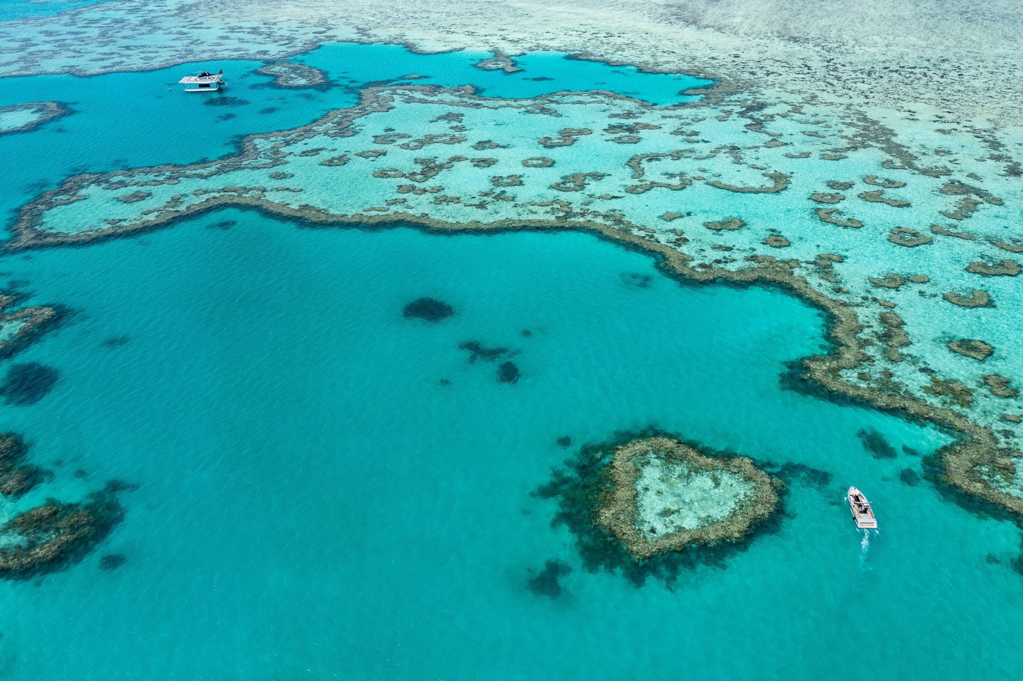 Scenic aerial view of turquoise ocean waters and coral reef