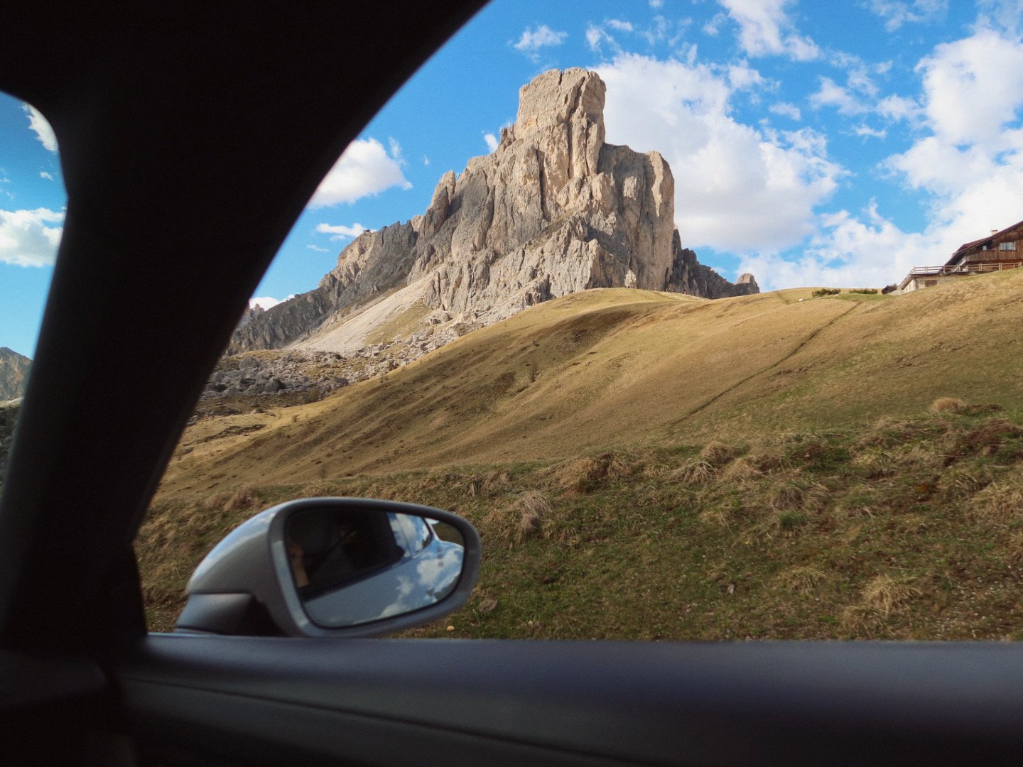 Ra Gusela peak at Passo Giau seen from inside a Porsche, Dolomites