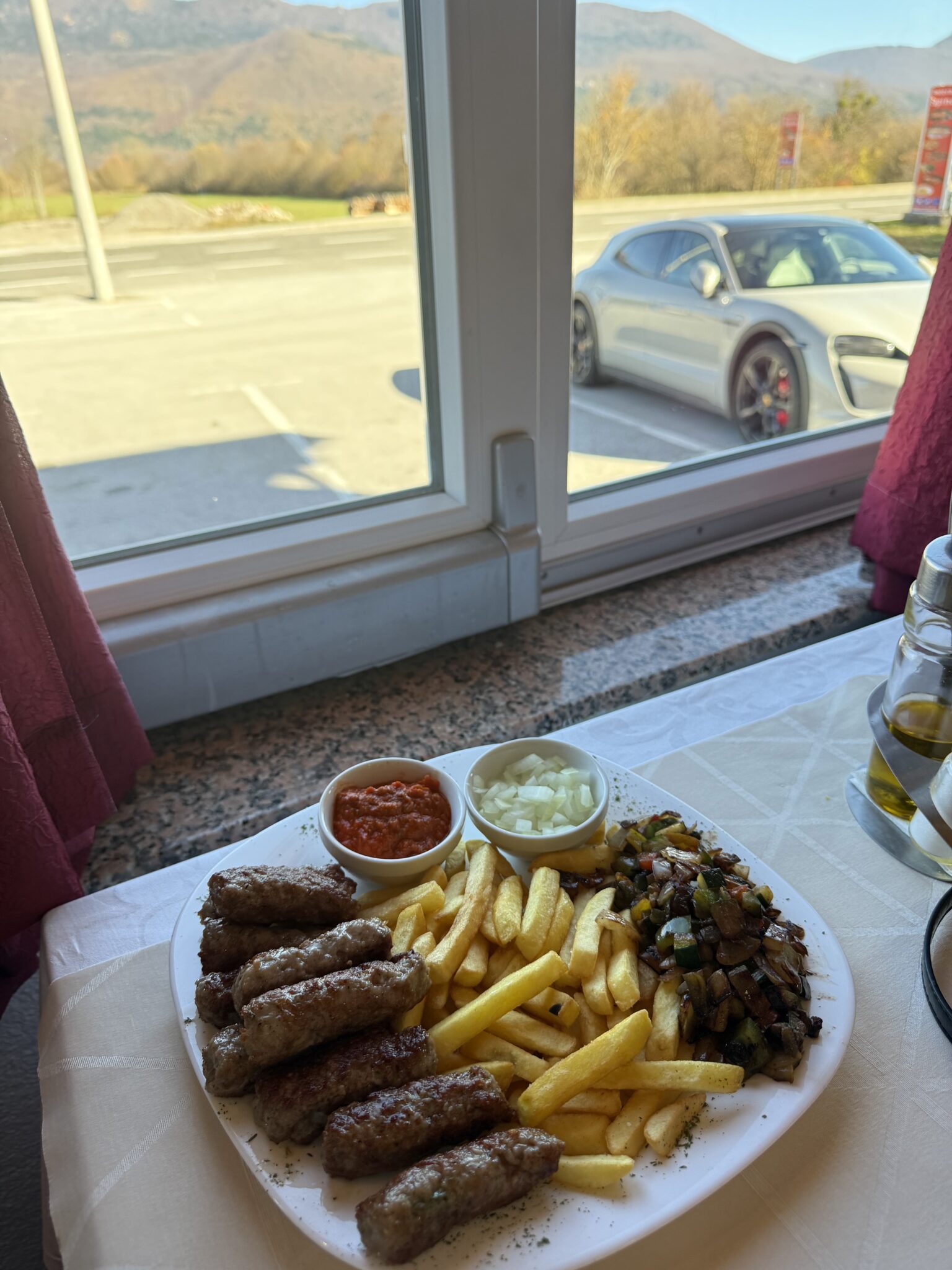 Kebabs with Porsche visible through the window