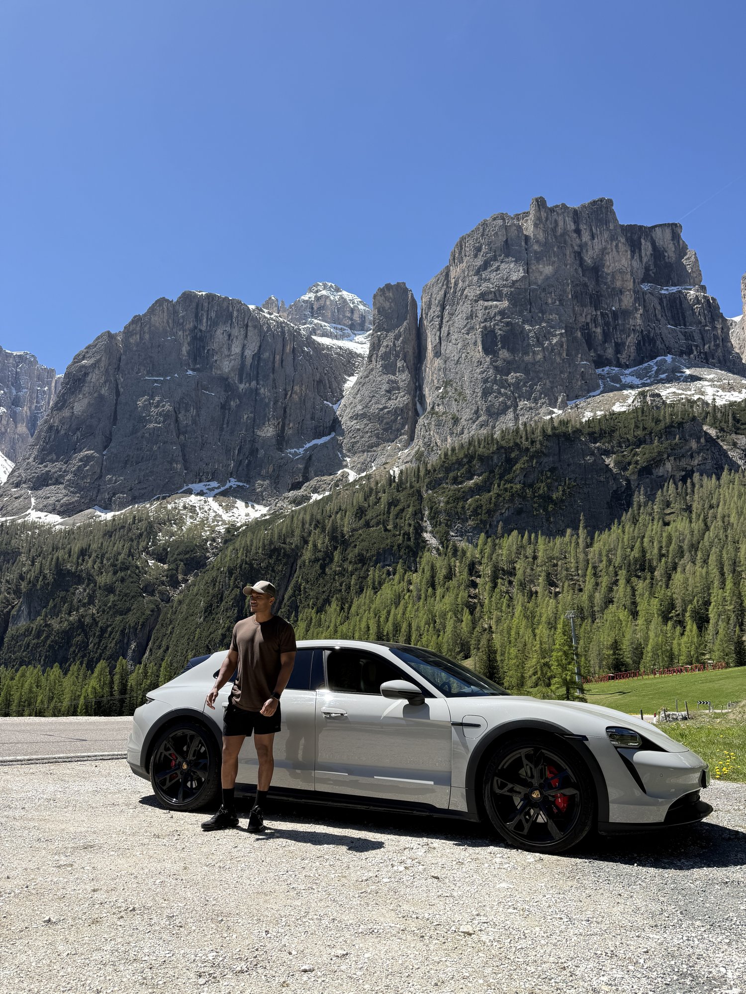 Tarik Bob with Porsche Taycan Cross Turismo below the Sella massif, Dolomites